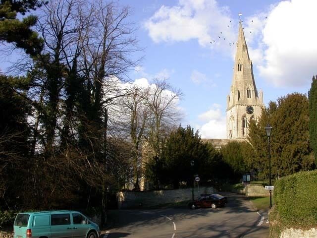 The junction of Cobbs Lane, Hickmire and Bell End in Wollaston, Northamptonshire. In the background are the tower and spire of St Mary the Virgin parish church.