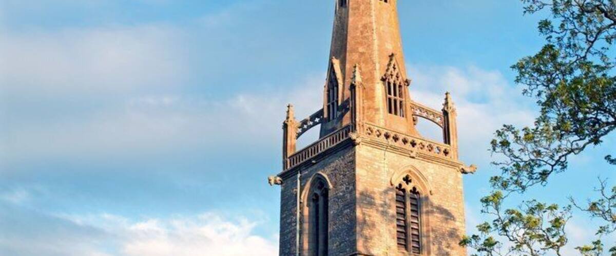 Easton Maudit Church. Sun going down mid May 2015. This church tower with its flying buttresses, the church and the surrounding village were important filming locations for the Father Brown tv episode "The Hammer of God" (1974).