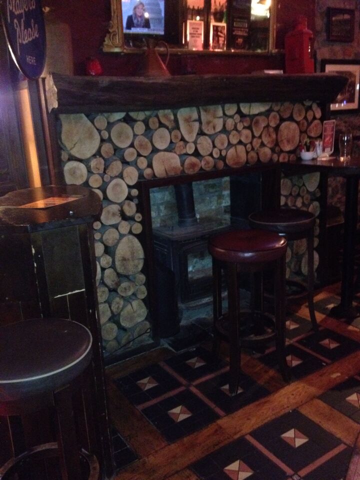 These are real wood logs around the fireplace, in a pub in Ennis, Ireland