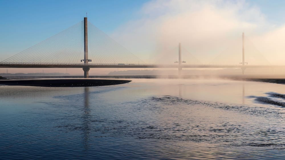 Cable-Stayed River Crossing Mersey Gateway Bridge in winter with fog