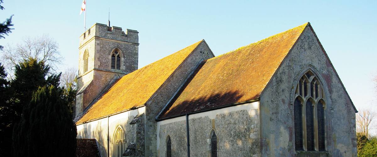 A historic church with a tower and a graveyard.