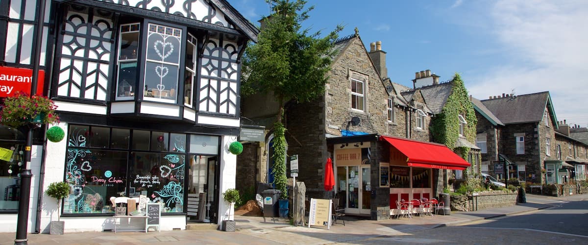 A street with traditional half-timbered buildings, a coffee bar, and a flower shop.