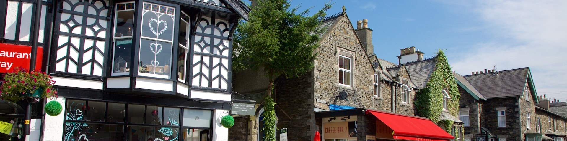 A street with traditional half-timbered buildings, a coffee bar, and a flower shop.