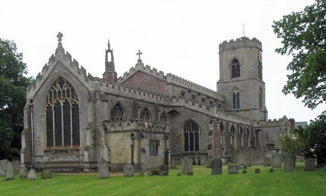 A Gothic-style church with a tall tower and arched windows.
