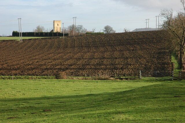 Farmland below Strensham Church Farmland between the moat on the site of the long gone Strensham Castle and the church which can be seen on the bank. The top of Bredon Hill can be seen on the horizon.