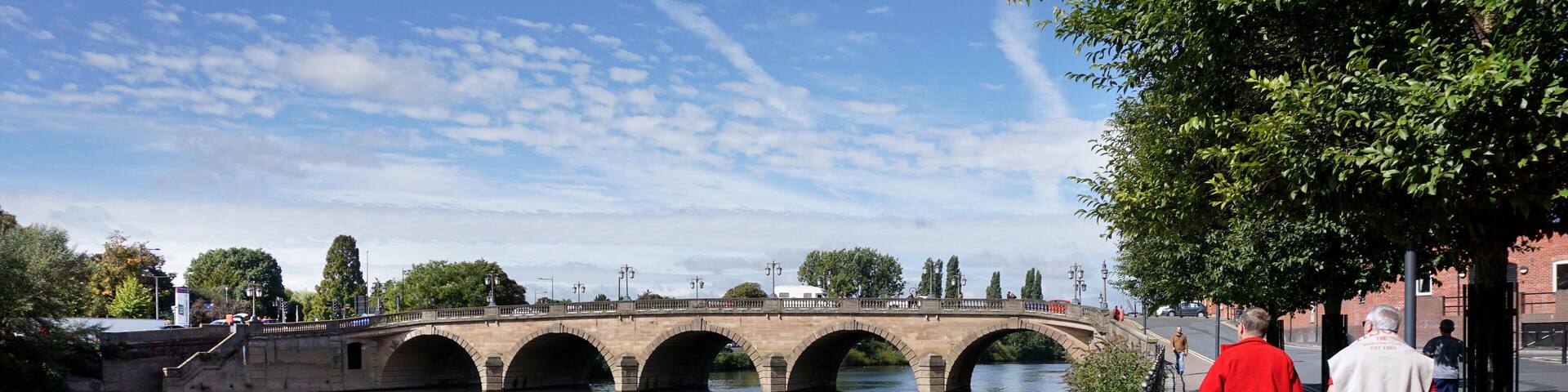 PKGNXN Men walking beside Bridge over river Seven Worcester England UK