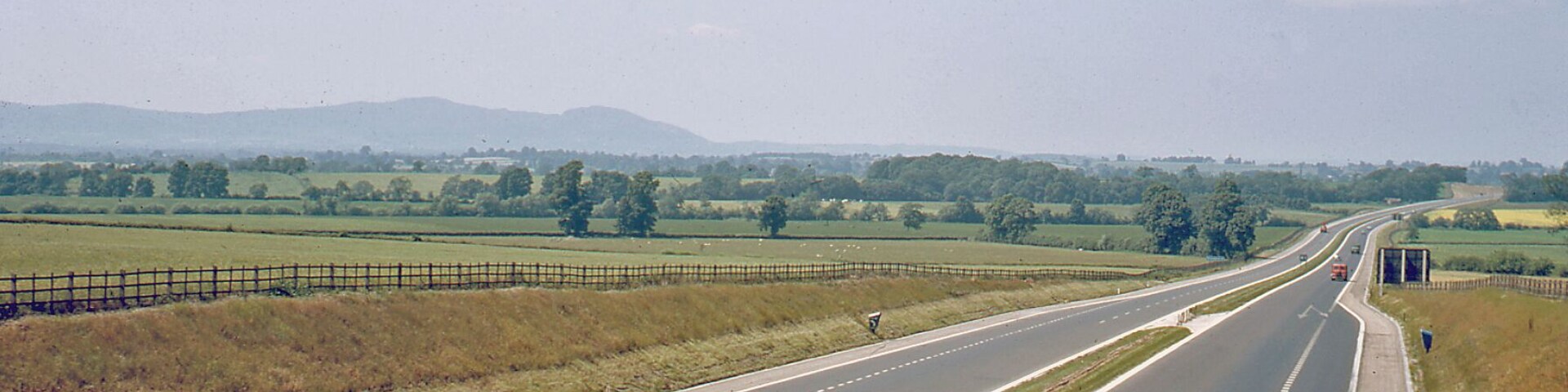 Northward on M5 Motorway at Strensham, 1964. View northward, towards Birmingham - at this date only to Junction 4 (Lydiate Ash), and not much traffic! In the distance are the Malvern Hills (Worcester Beacon (1,355 ft.), North Hill (1,307 ft.))