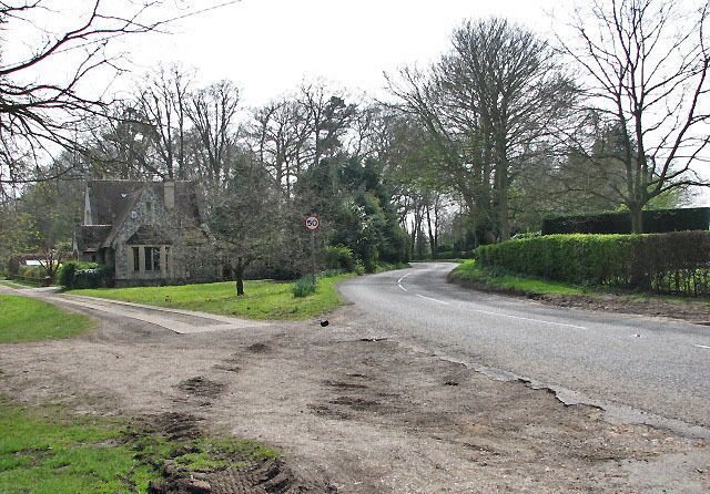 South on Wymondham Road (B1135) Past the private road to Kimberley Hall (seen at left); the gatehouse seen at left is School Lodge.
