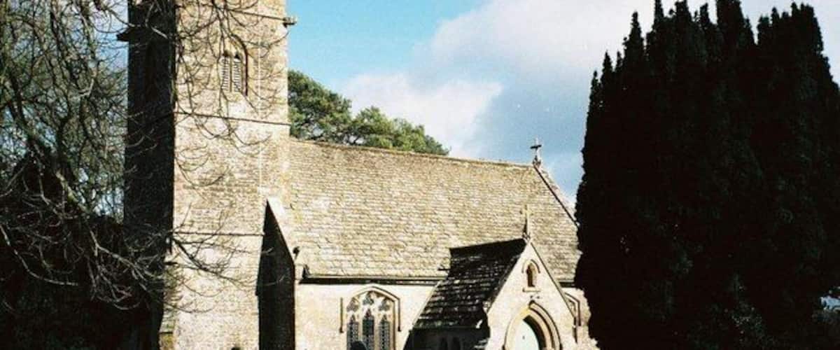 A stone church with a tall tower and pointed arches.