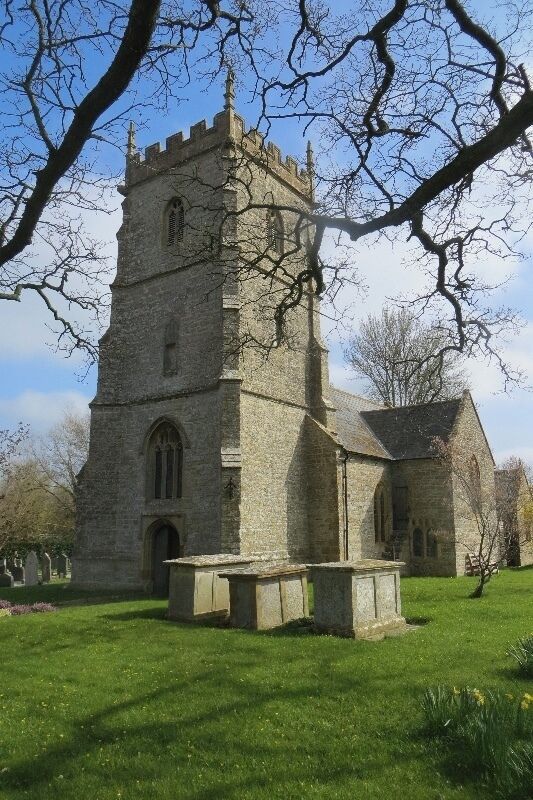 A stone church with a tall tower and arched windows.