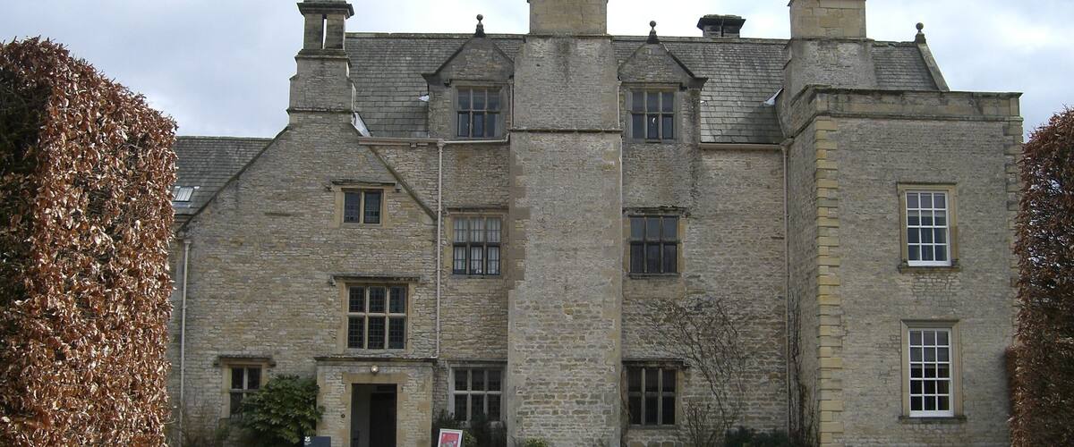 A large stone building with multiple chimneys and windows.