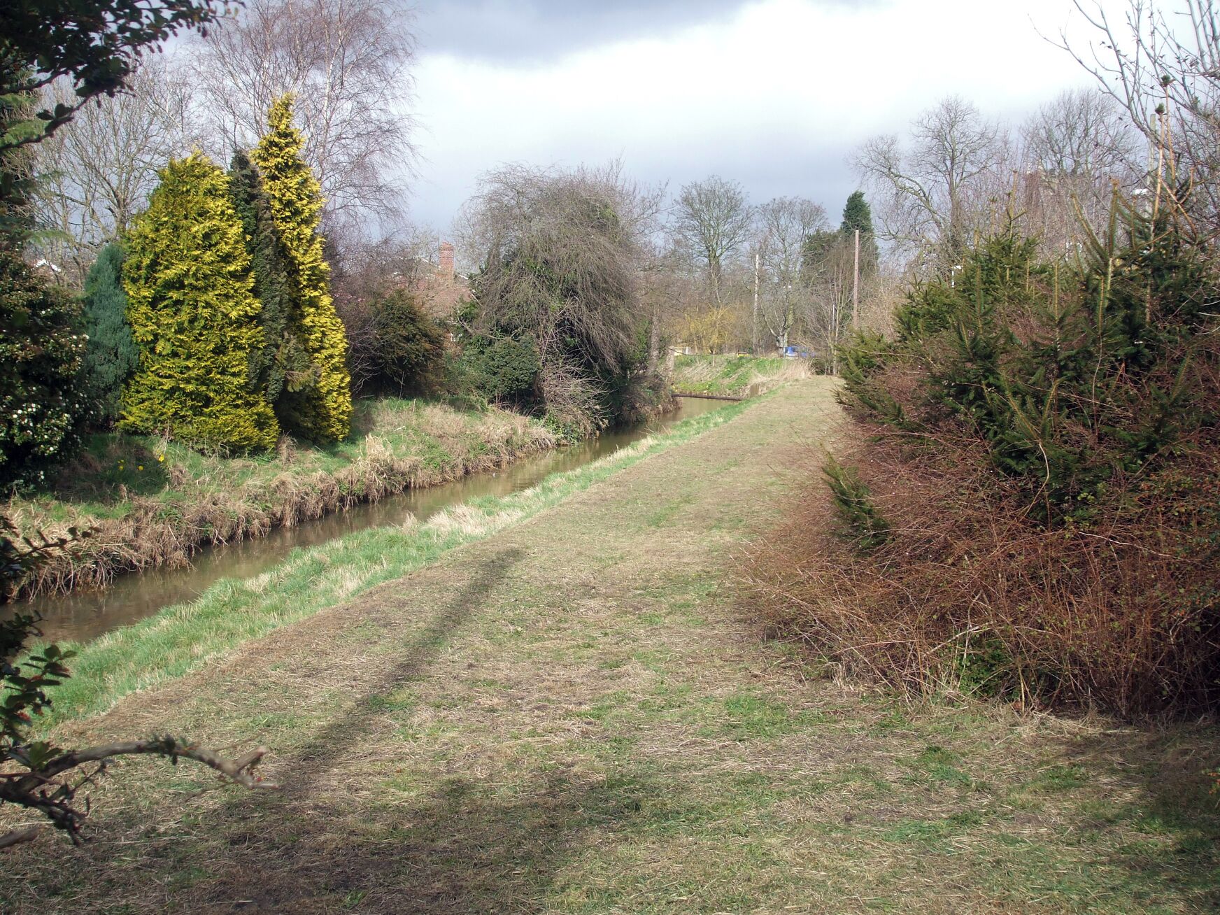 Foss Beck In March Taken from the Water Board Gate slightly north of Butcher Bridge facing north shortly after the grass had been cut. With the sun shining the area appears clean and tidy.