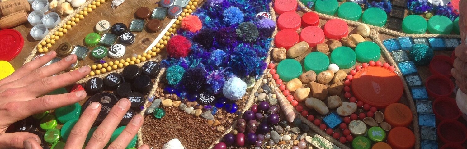 A mosaic table with colorful bottle caps and beads.