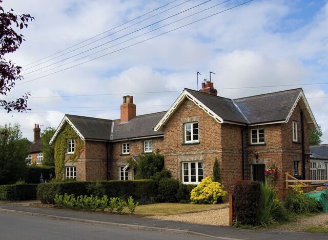 Houses in Everingham, East Riding of Yorkshire, England. On the western side of the village's main street. From their appearance I would guess that they were originally built for estate workers at the nearby Everingham Hall.