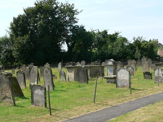 Leaning Left And Right. Graves in the churchyard of Bulmer Parish Church