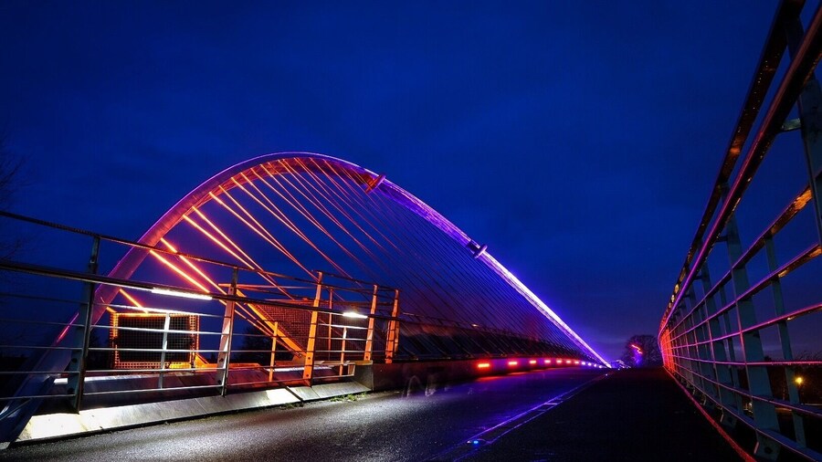 The Millennium Bridge over the River Ouse is li up at night with coloured LEDs. #yorkshire #york #riverouse #Bridge #illuminated