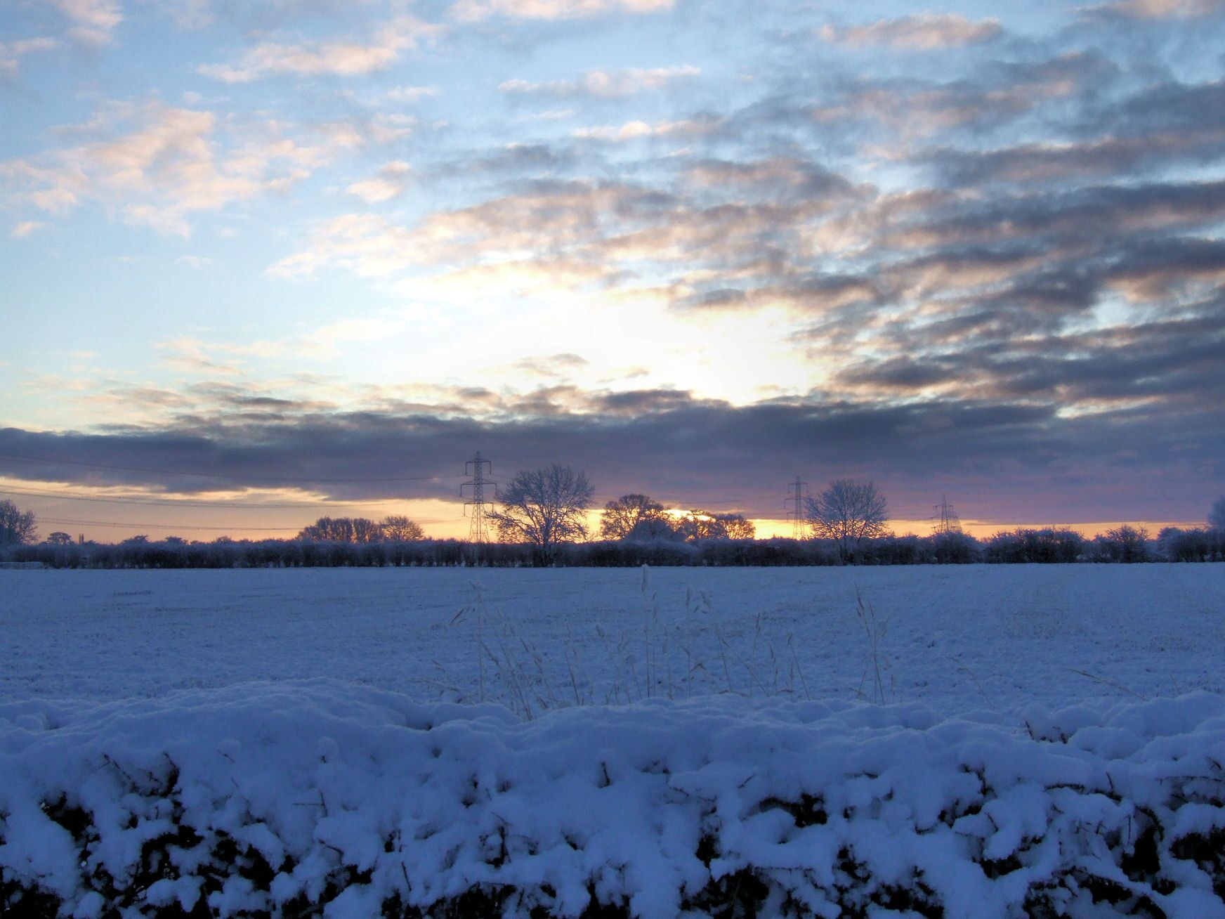 Snowy Sunset at Wilberfoss, East Riding of Yorkshire, England. Taken from the A1079 towards the A1079.
