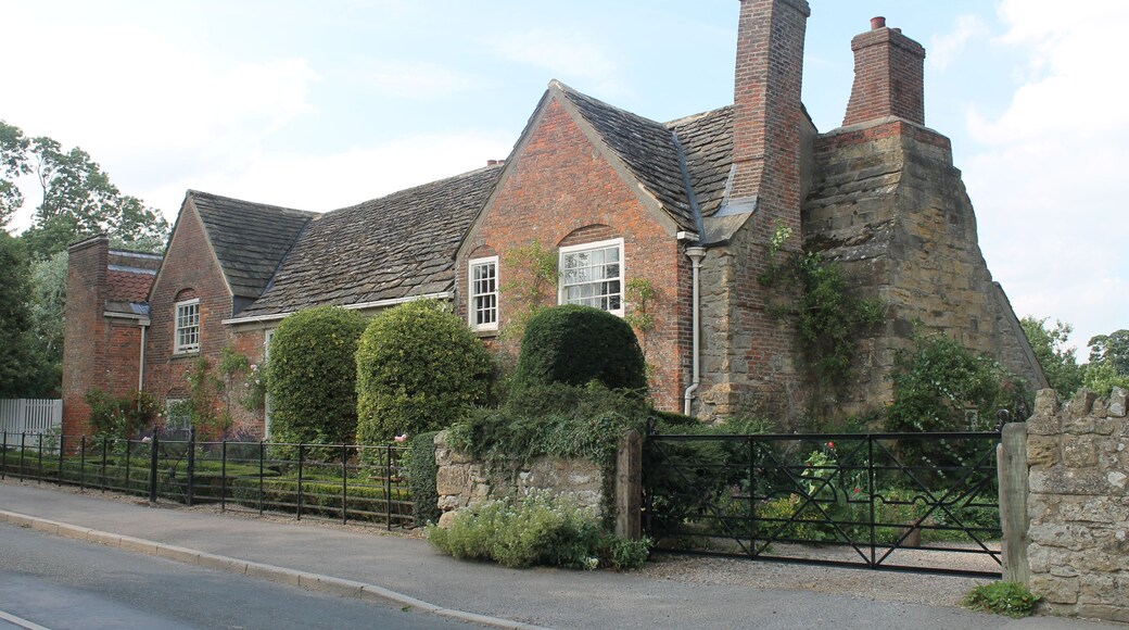 The south entrance to Shandy Hall. The wrought iron gates include a bar in the shape of one of the plot-lines drawn by Laurence Sterne in The Life and Opinions of Tristram Shandy.