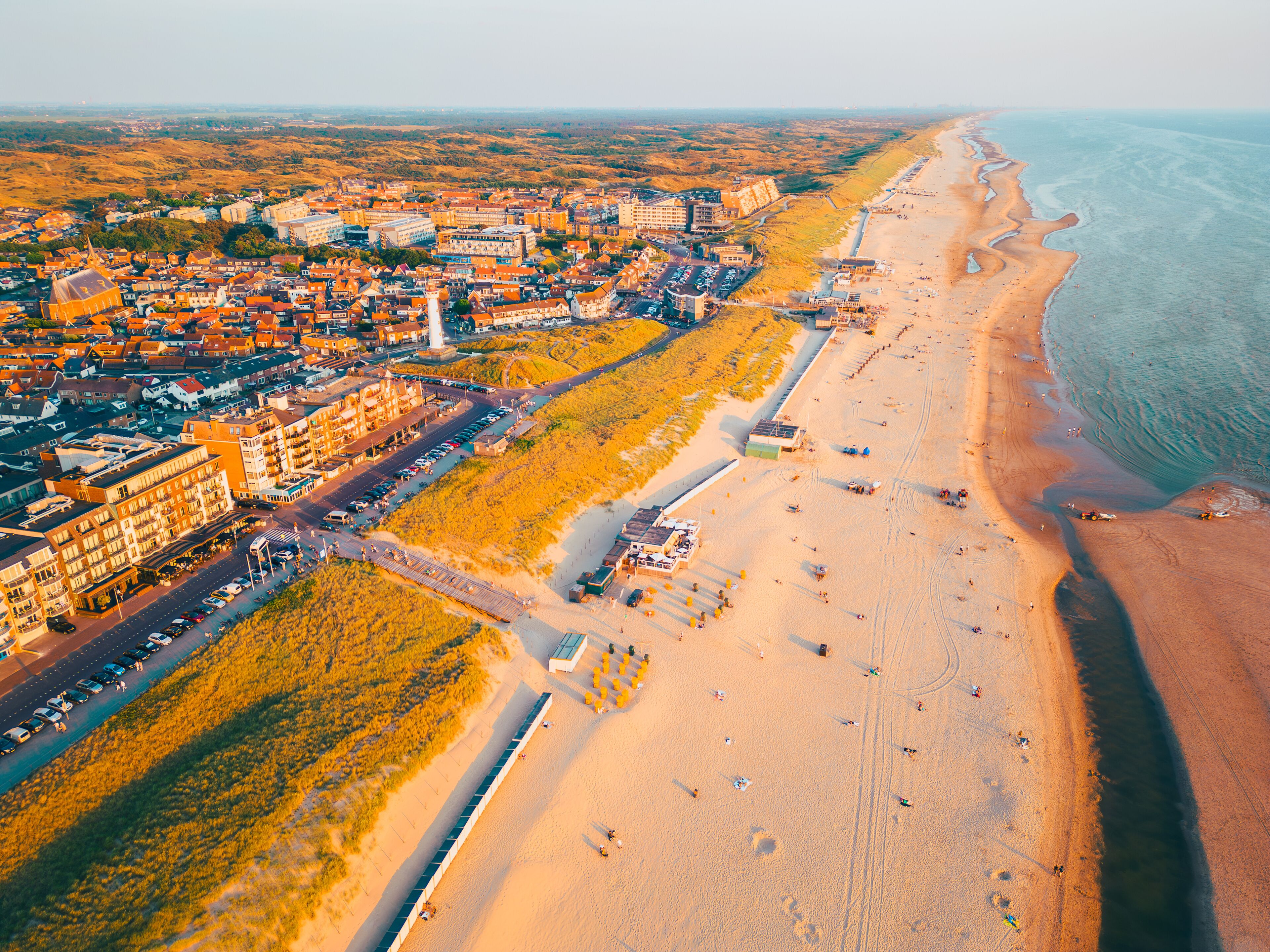 High angle Drone Point of View on Coastal Village of Egmond aan Zee, North-Holland, The Netherlands on spring day around sunset