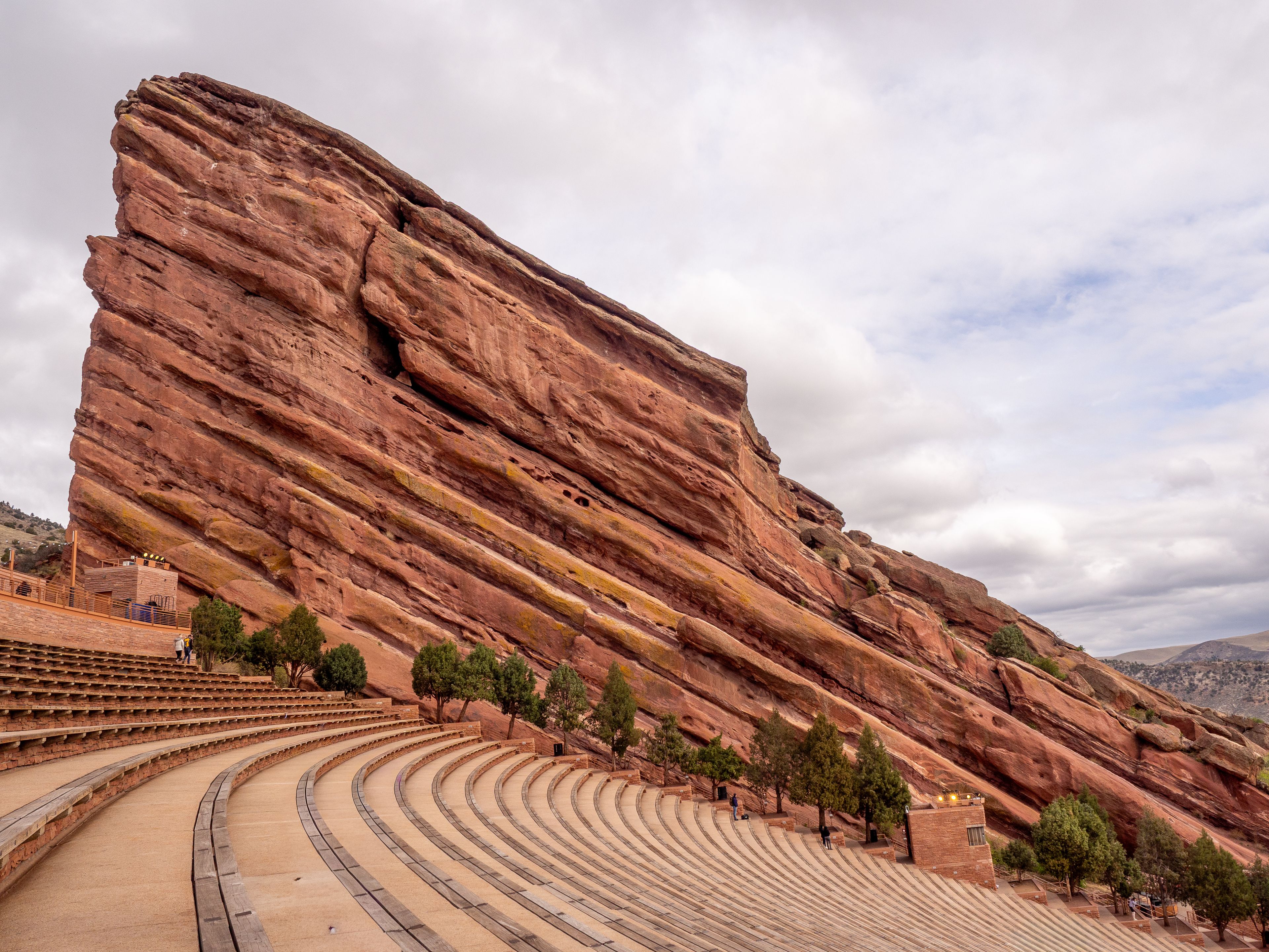 A large red rock formation with a theater built into its side.