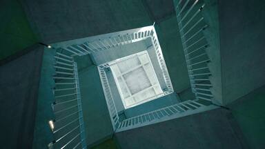 A staircase in the middle of the building, enjoy the spinning effect while looking upward