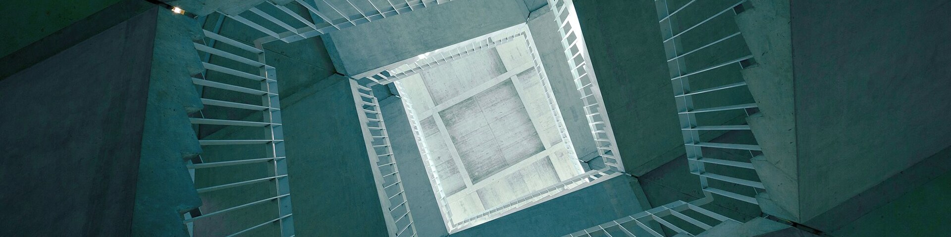 A staircase in the middle of the building, enjoy the spinning effect while looking upward