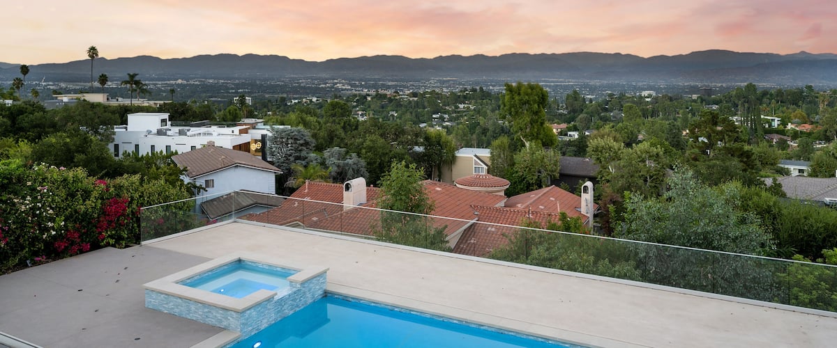 Luxurious home with pool and lush green surroundings in Encino, California