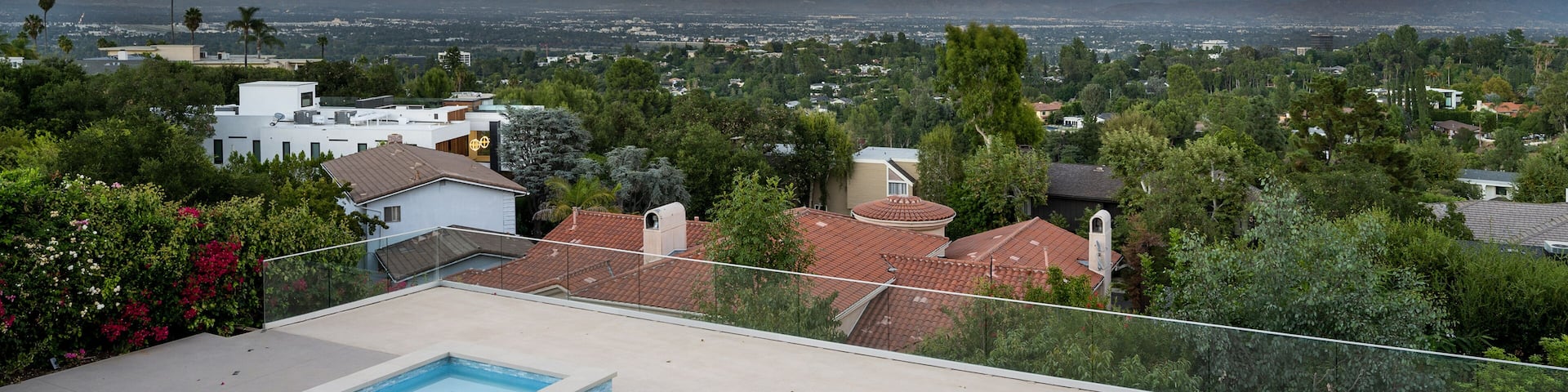Luxurious home with pool and lush green surroundings in Encino, California