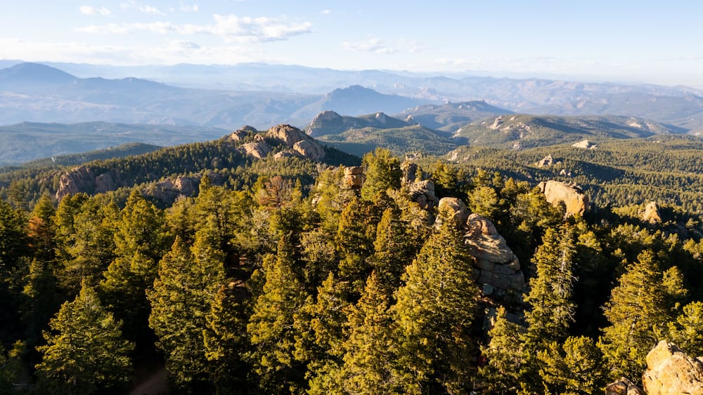 Spectacular 360-degree views from the historic Devil's Head Lookout atop a granite pinnacle in the Rampart Range of Pike National Forest, featuring rugged peaks and vast Colorado wilderness.