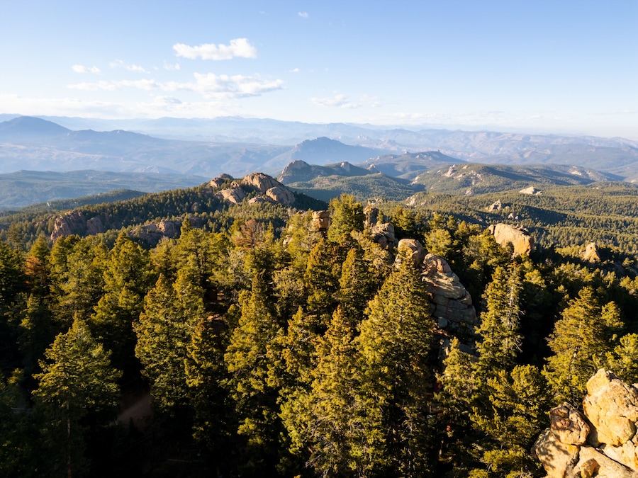 A mountainous landscape with dense forests and rocky outcrops.