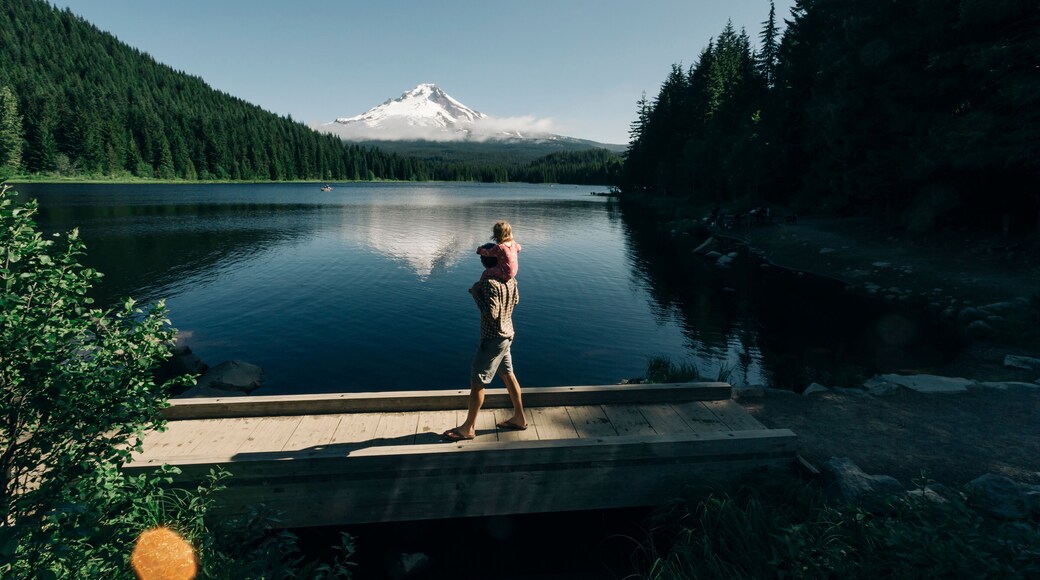 A father carries his daughter on his shoulders at Trillium Lake, OR.