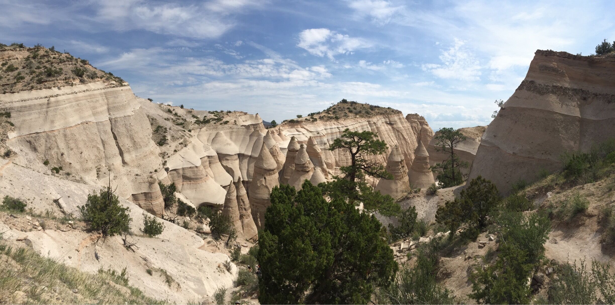 The Tent Rocks Canyon trail it is a hiking trail through a slot canyon with hoodos and striated rock formations. It's a nice climb, about 750 ft elevation increase in about 3 miles. Going though tunnels and up ledges. There are railroad ties to make steps to get to the top where you can see for miles! It is truly breathtaking!! #lifeatexpedia 