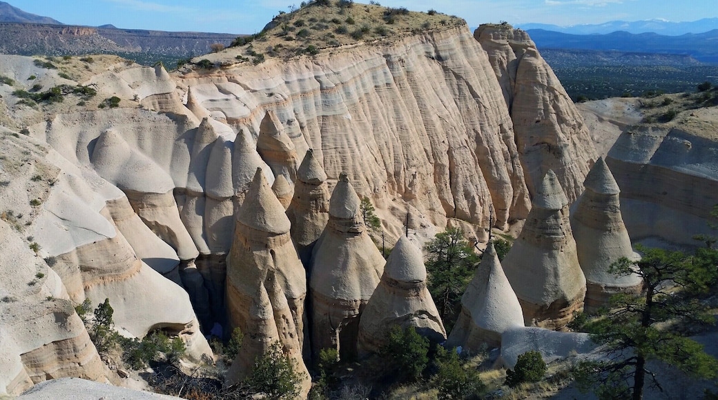Halfway between Albuquerque and Santa Fe on New Mexico’s Highway 25, hang a left (if you’re heading north) and be prepared for some unusual and magnificent rock formations courtesy of mother nature, the Bureau of Land Management, and the American Indian Pueblo de Cochiti.
The Kasha-Katuwe Tent Rock National Monument owes its remarkable geology to layers of volcanic rock and ash deposited by pyroclastic flow 6 to 7 million years ago from a volcanic explosion within the Jemez Volcanic Field; and to the gentle hand of time as wind and water smoothed the pumice, ash and tuff deposits.
Bring your hiking boots along with your camera and see the tent rocks up close and personal for a $5 fee (per vehicle) via two separate trails that offer superb views of this natural wonder. Hike to the top of the Canyon Trail for magnificent views of central New Mexico only possible from almost 7,000 feet above sea level.
See more pictures and commentary of our hike via my travel blog at http://www.aplacecalledroam.com/home/hiking-the-stunning-kasha-katuwe-tent-rocks-national-monument .