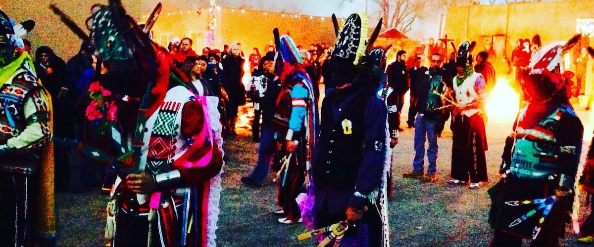 A group of people in colorful traditional costumes, possibly at a cultural event or festival.