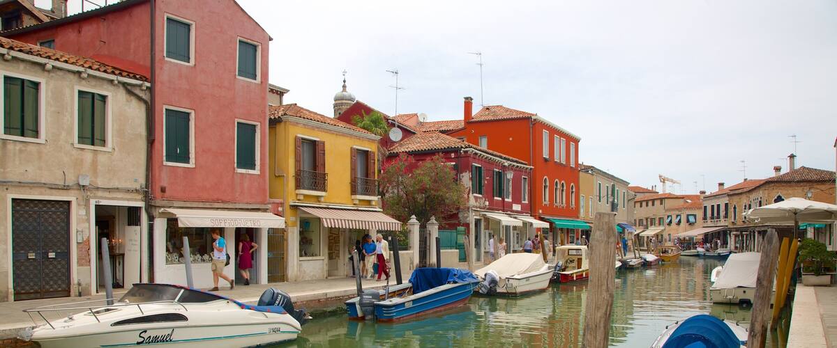 A canal in Venice with colorful buildings and boats.