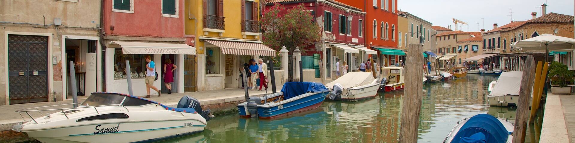 A canal in Venice with colorful buildings and boats.