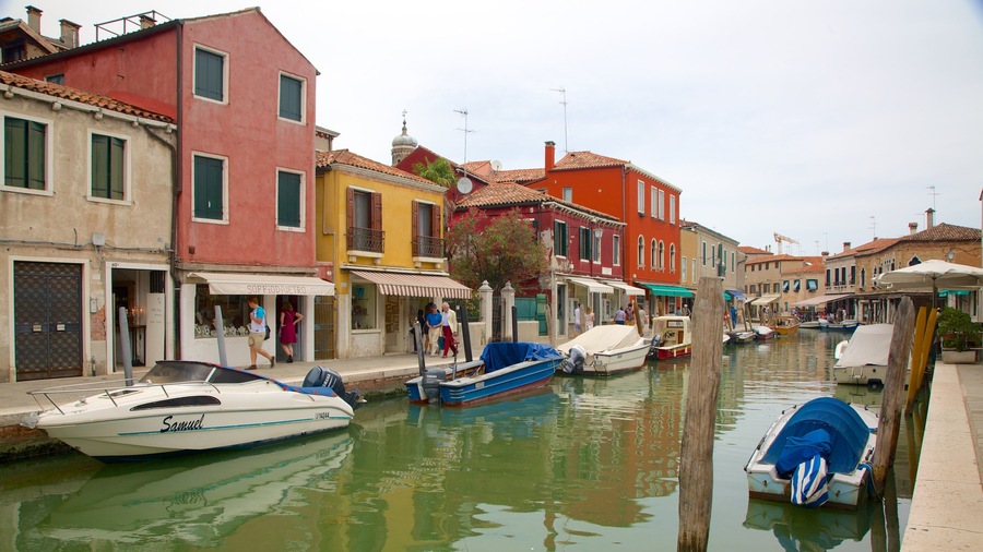 A canal in Venice with colorful buildings and boats.