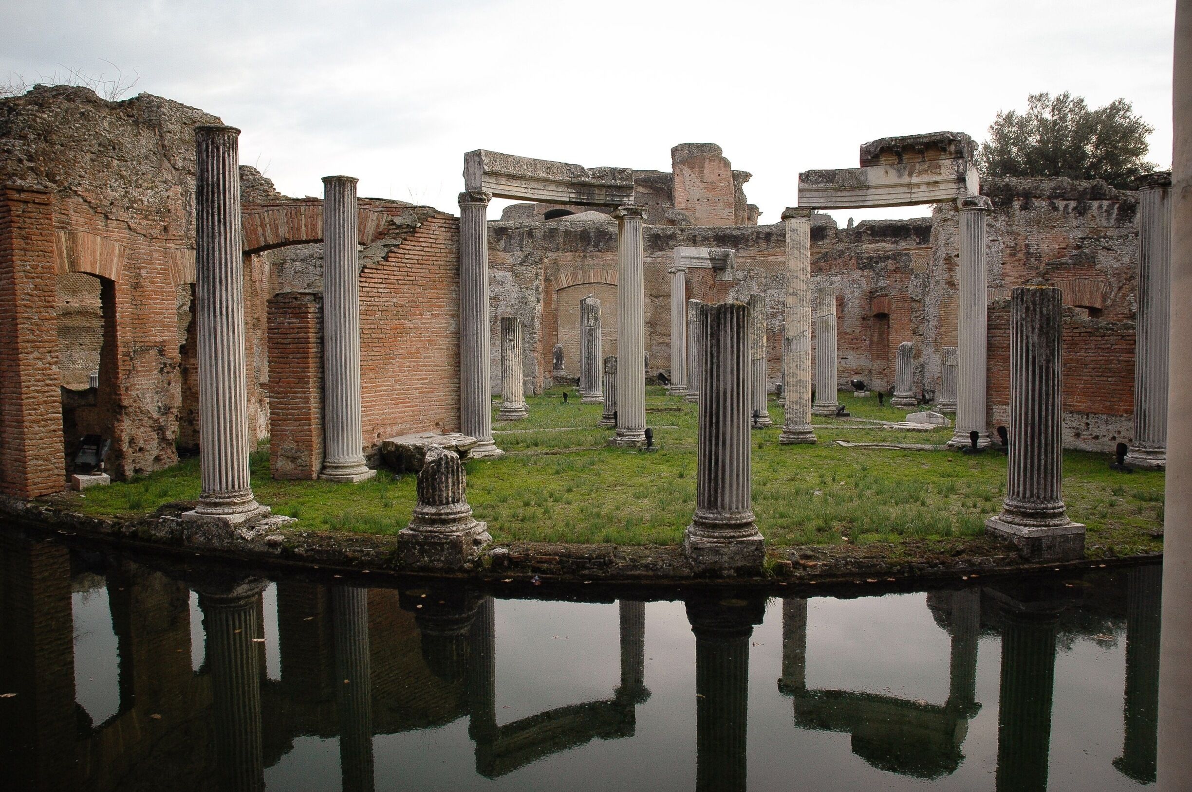 Ancient ruins with columns and brick structures.