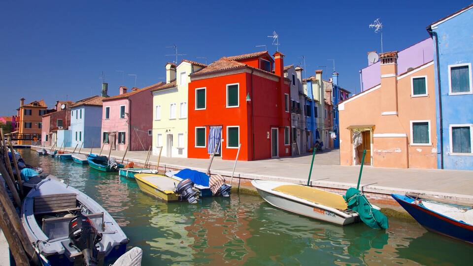 A canal with colorful buildings and boats.