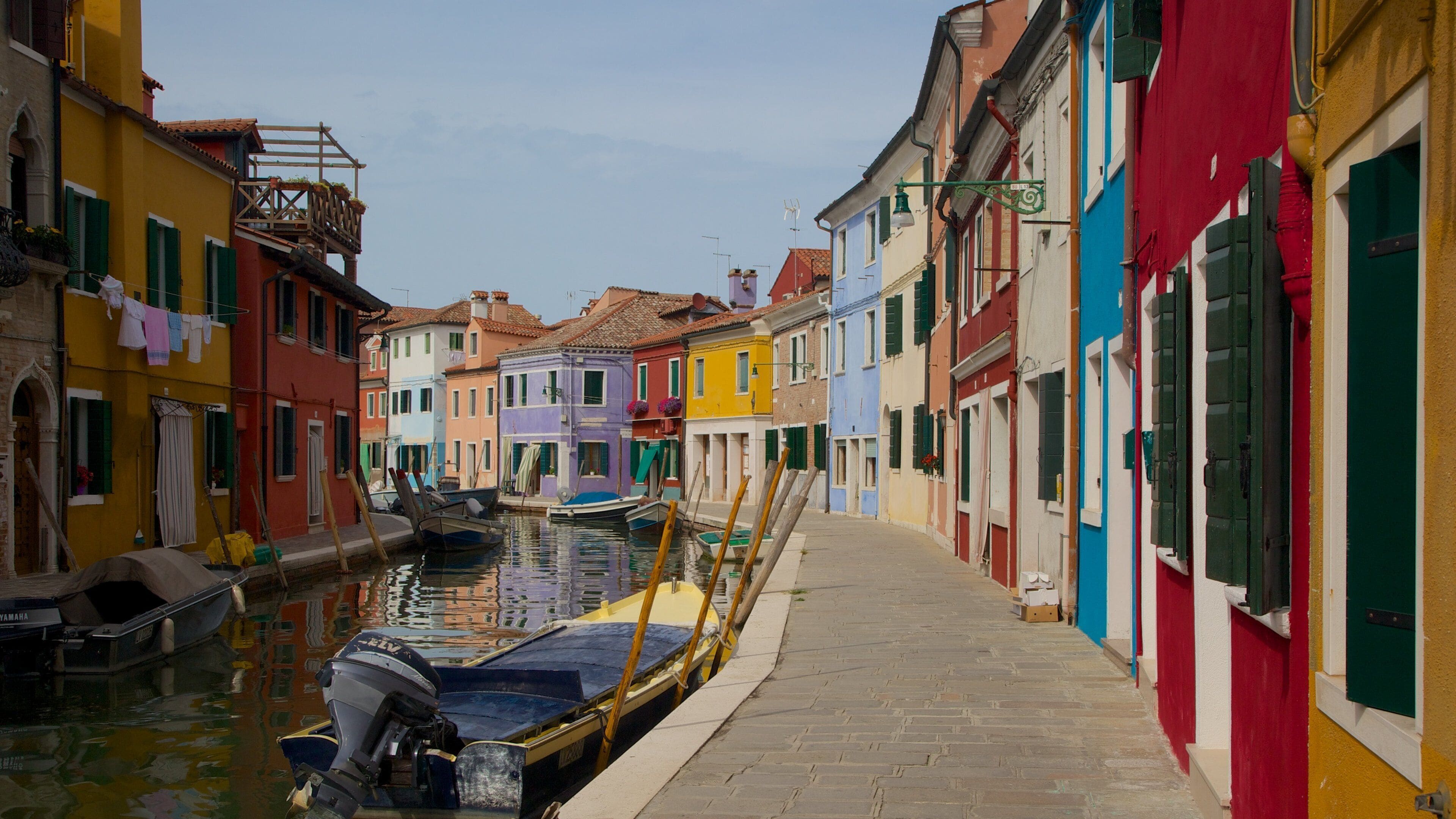 A narrow canal with colorful buildings on either side.