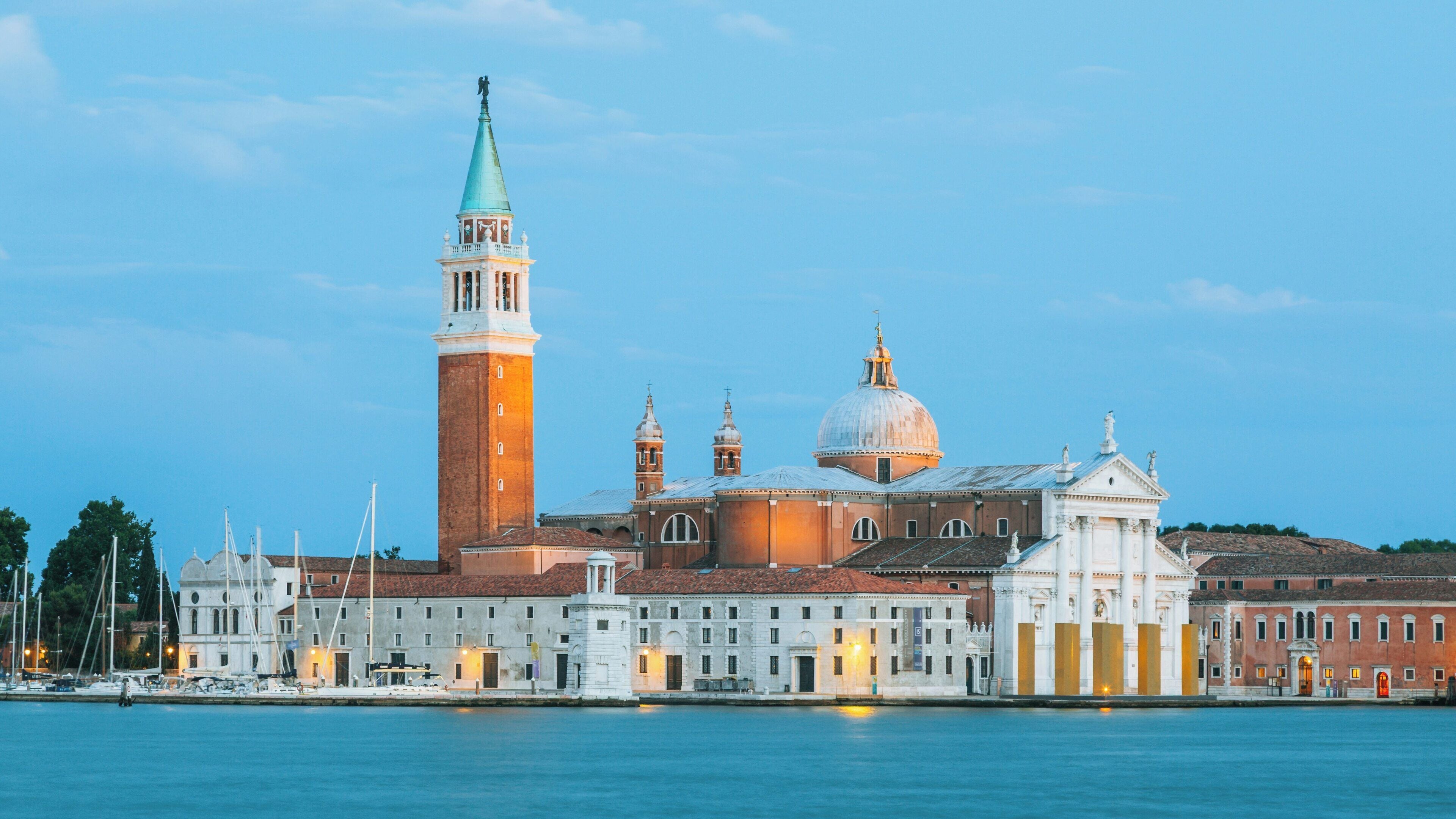 San Giorgio Maggiore in Venice showcases its iconic architecture against a serene evening sky with gentle water reflections