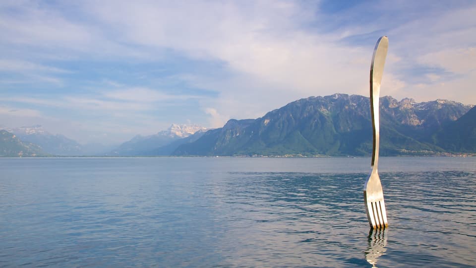 A fork in the water with mountains in the background.