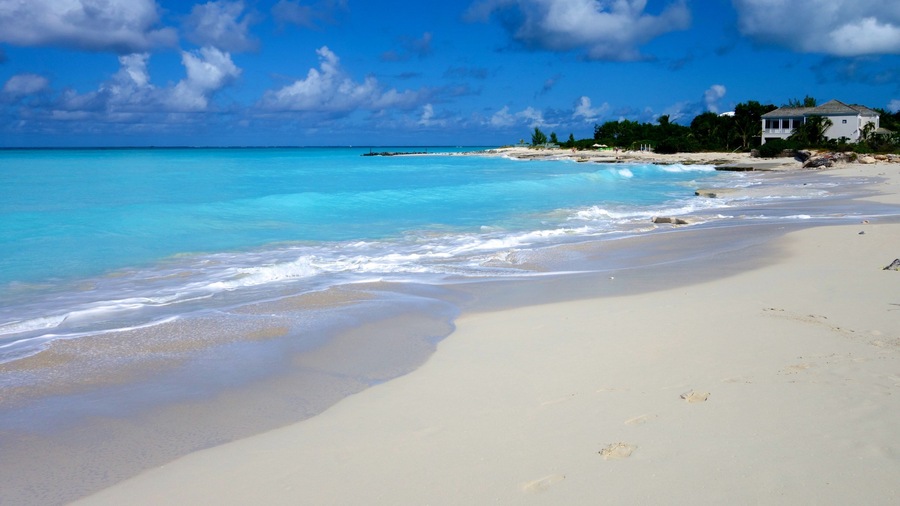 Grace Bay which includes a sandy beach, tropical scenes and a house
