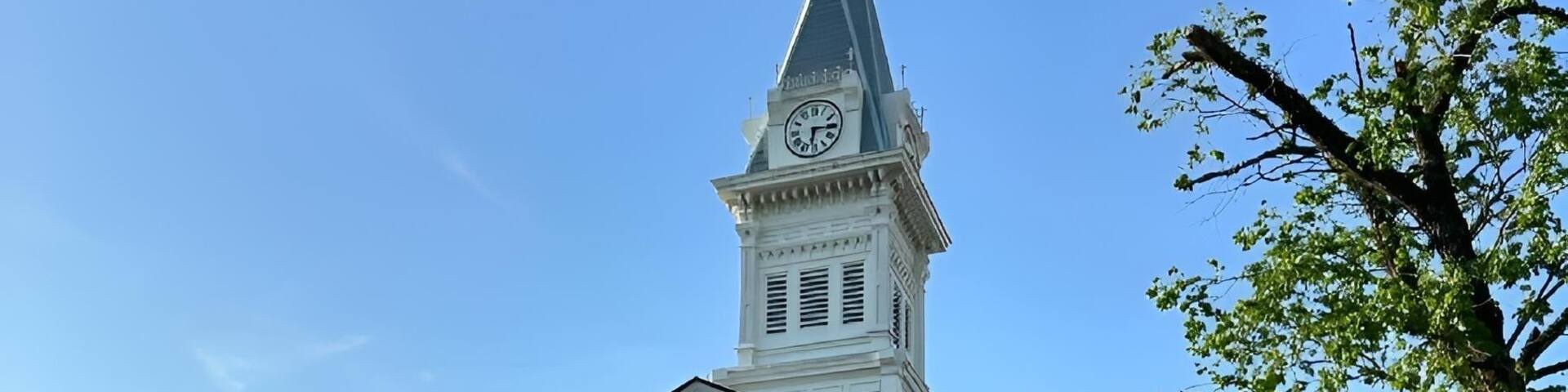 Historic Baldwin County Courthouse under a clear blue sky on a sunny day