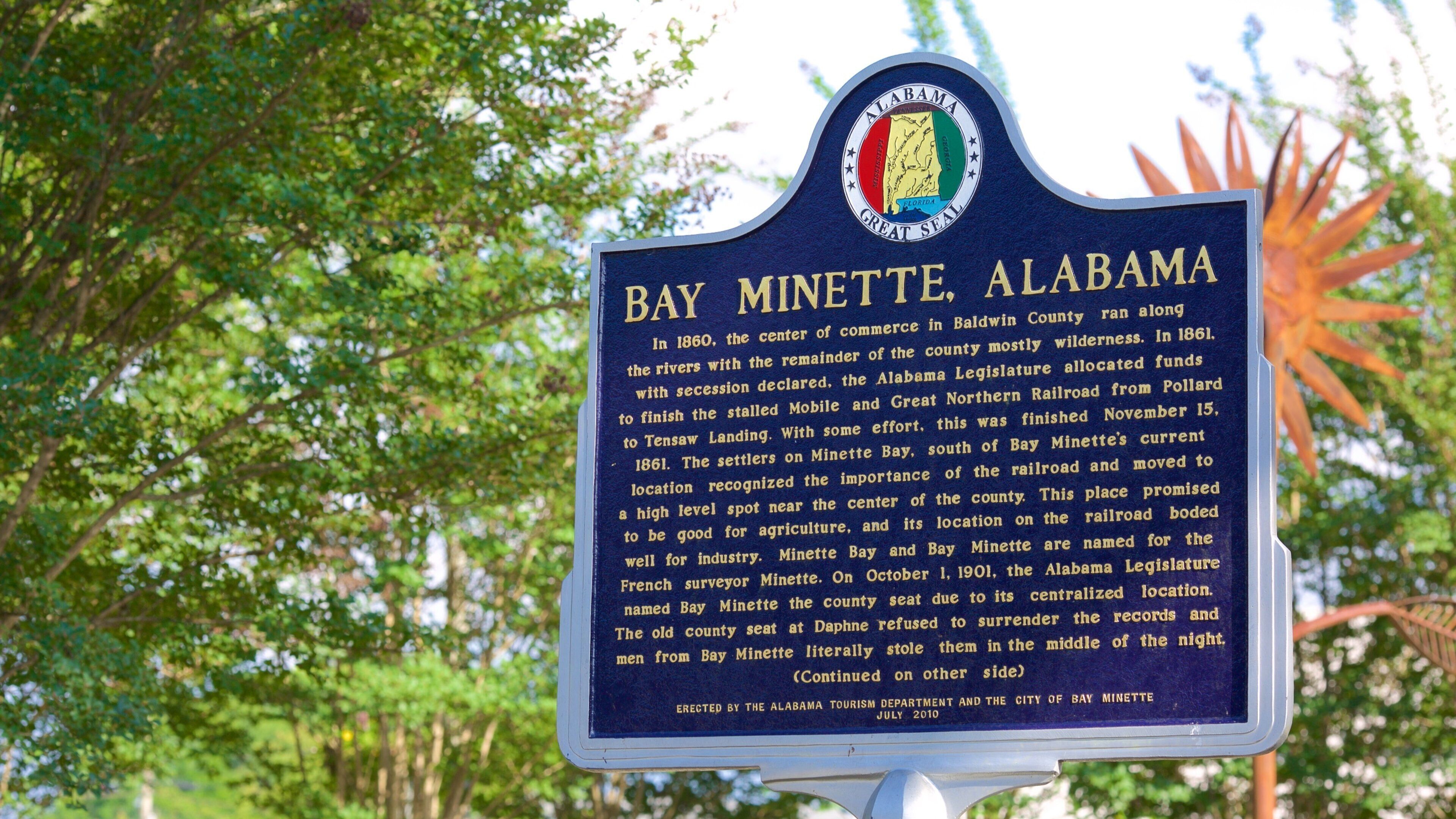 A historical marker sign for Bay Minette, Alabama.