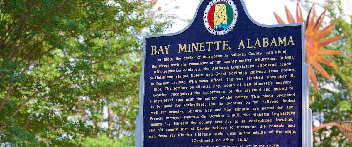 A historical marker sign for Bay Minette, Alabama.