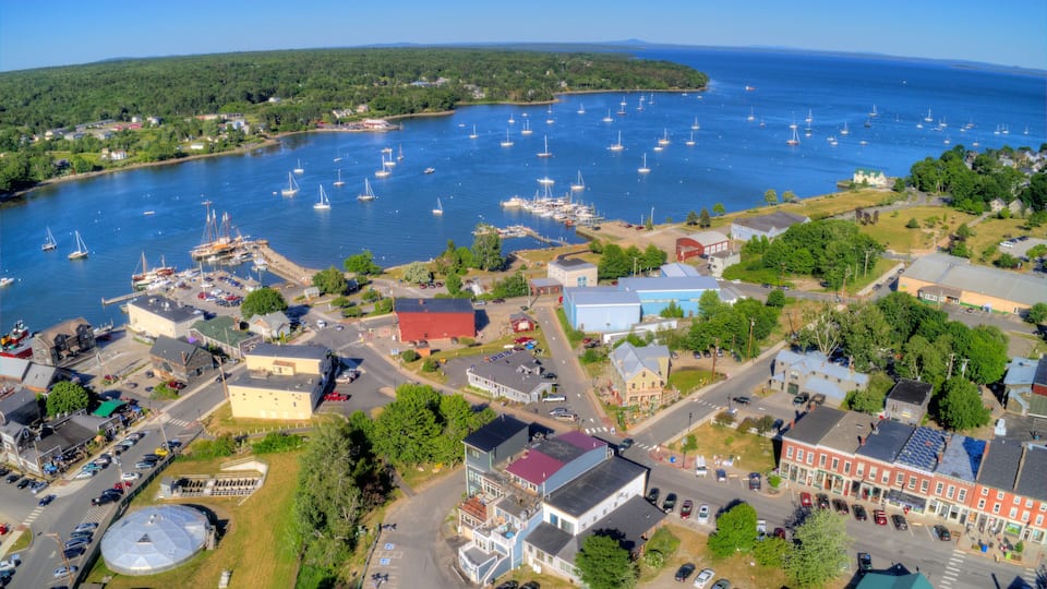 A coastal town with a marina, boats, and buildings.