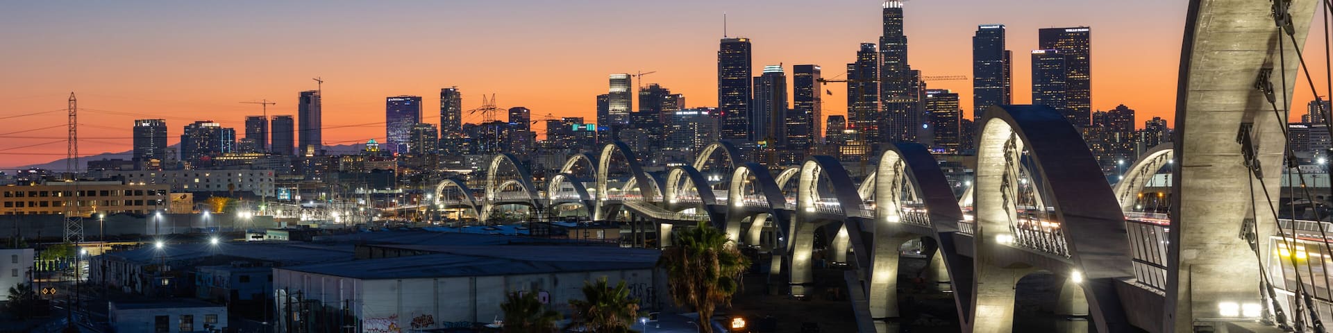 New 6th Street bridge in Los Angeles at sunset with the Los Angles skyline in the distance