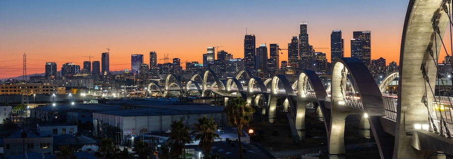 New 6th Street bridge in Los Angeles at sunset with the Los Angles skyline in the distance