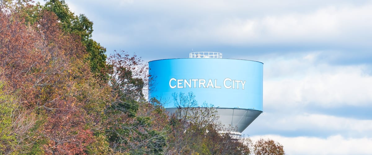 A water tower labeled "Central City" amidst autumn foliage.